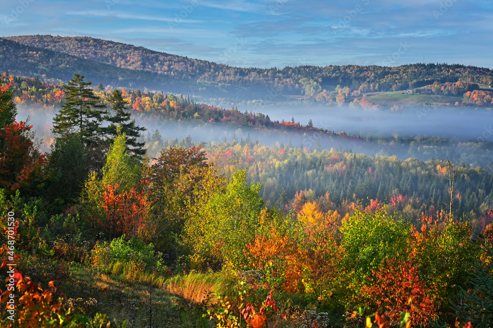 Autumn vista across the New England mountains as the morning fog lifts