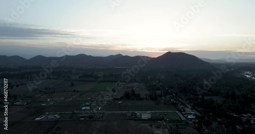 Aerial view of a sunset in Pirque with the mountains in the background as the sun goes down. photo