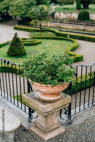 Greenery in a bowl on a stone pedestal in the garden near Villa Trivulzio. Italy, Lake Como
