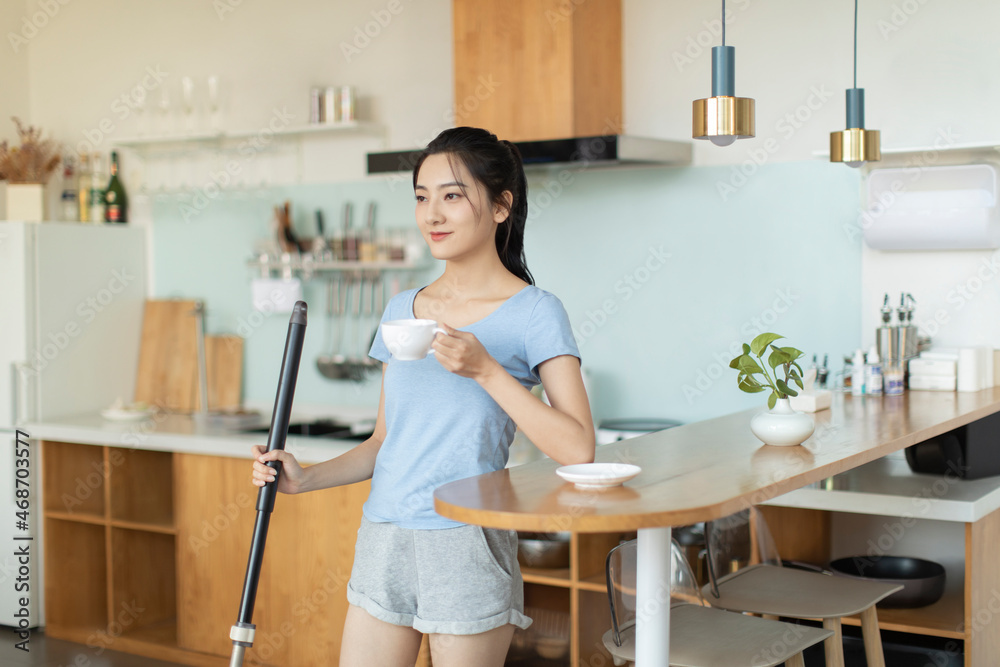 Cheerful young woman doing housework