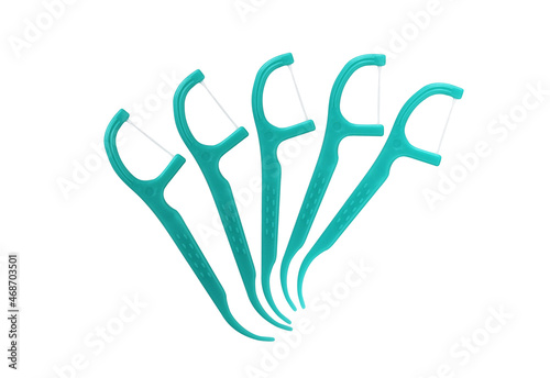 5 Green Dental Floss Picks (Plastic) isolated on a white background. Dental floss with handle, easy to use. photo