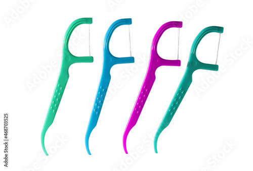 4 Dental Floss Picks (Plastic) isolated on a white background. (Green, Blue, Pink) Dental floss with handle, easy to use.