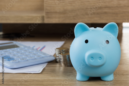 Saving money concept,piggy bank with coin money on table,selective focus.