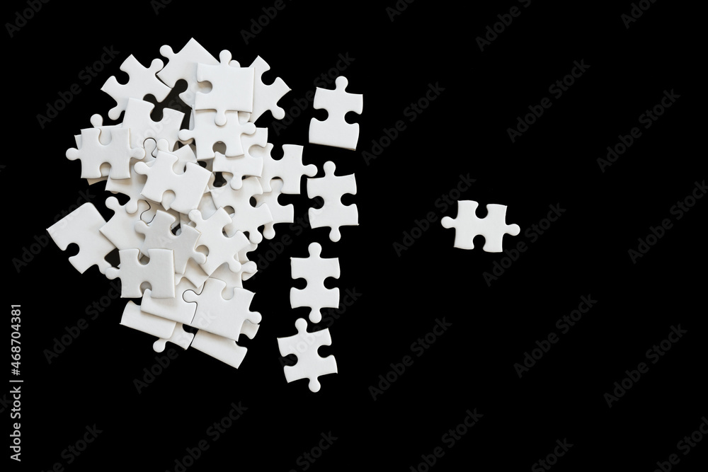 White jigsaw puzzle on black background. White jigsaw puzzle on black background.