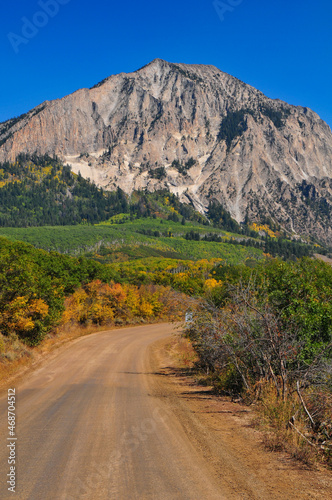 Rugged Marcellina Mountain surrounded by fall colors as seen from the Kebler Pass mountain road, on the way to Crested Butte, Colorado, USA