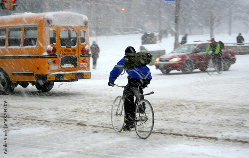 Photography intrepid urban cyclists braving traffic in a blizzard