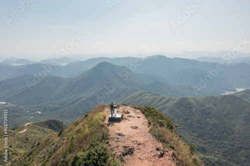 Amazing panorama of Man standing of Sharp Peak, Sai Kung, Hong Kong.