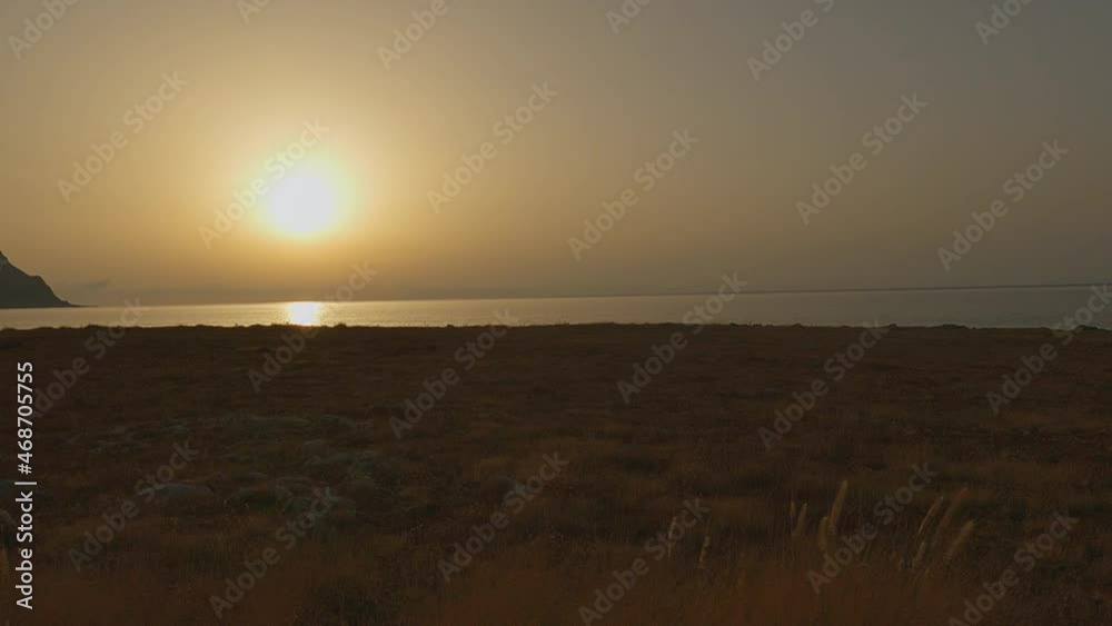 Breathtaking sunset at Baia Santa Margherita at Monte Cofano Sicilian natural reserve as seen from moving car, Italy. Slow-motion Breathtaking sunset at Baia Santa Margherita at Monte Cofano Sicilian natural reserve as seen from moving car, Italy. Slow-motion