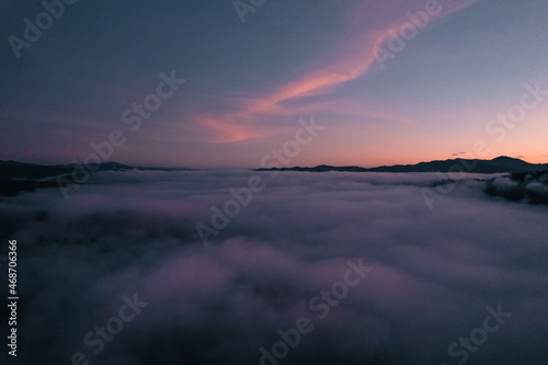 Flying above the clouds sunrise and fog