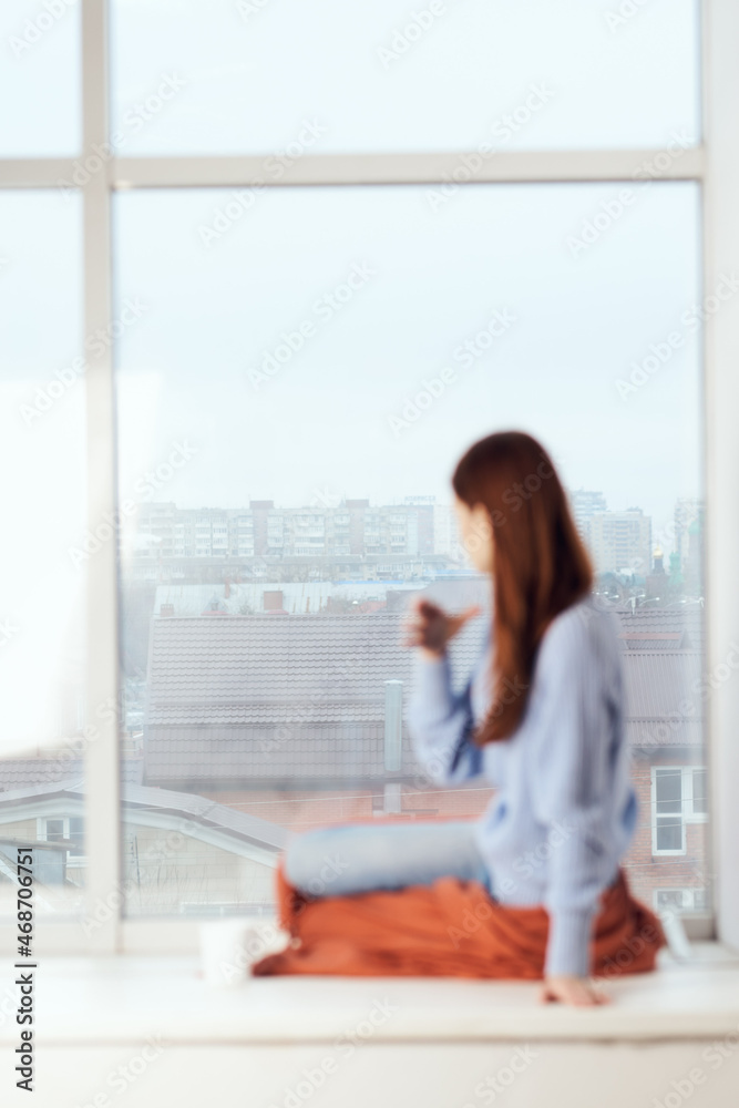 woman near the window dreamy look rest at home comfort woman near the window dreamy look rest at home comfort