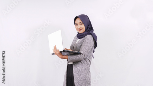 smiling young asian woman on the laptop isolated on white background
