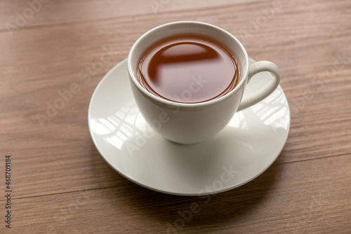 A cup of tea on a wooden background.
