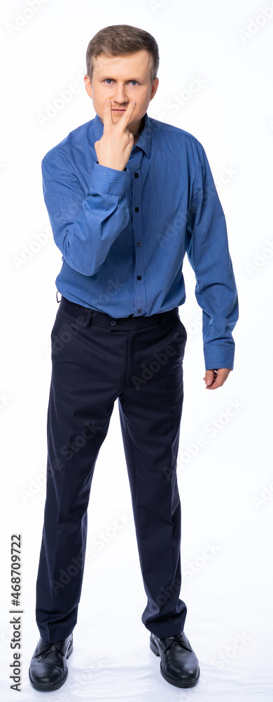 a man in the studio on a white background in trousers and a shirt shakes his fingers a man in the studio on a white background in trousers and a shirt shakes his fingers