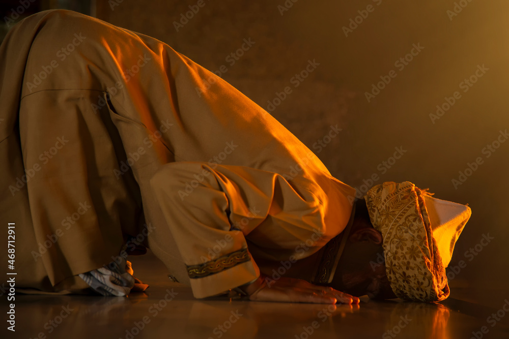 Muslim man praying and prostrating In the mosque that is the teaching ...