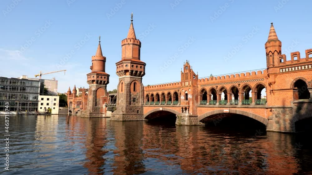 Oberbaum Bridge (Oberbaumbrucke) over River Spree at sunset in Berlin, Germany, North German Brick Gothic style architecture, city landmark from 1895. Oberbaum Bridge (Oberbaumbrucke) over River Spree at sunset in Berlin, Germany, North German Brick Gothic style architecture, city landmark from 1895.