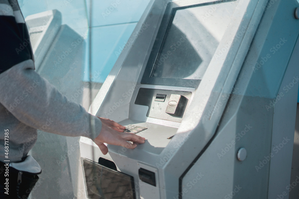 male person using atm bank terminal to make some cash operations male person using atm bank terminal to make some cash operations