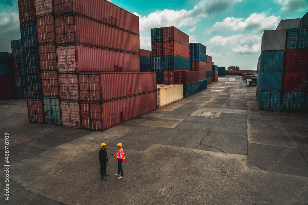 © Summit Art Creations - Industrial worker works with co-worker at overseas shipping container yard . Logistics supply chain management and international goods export concept . © Summit Art Creations - Industrial worker works with co-worker at overseas shipping container yard . Logistics supply chain management and international goods export concept .