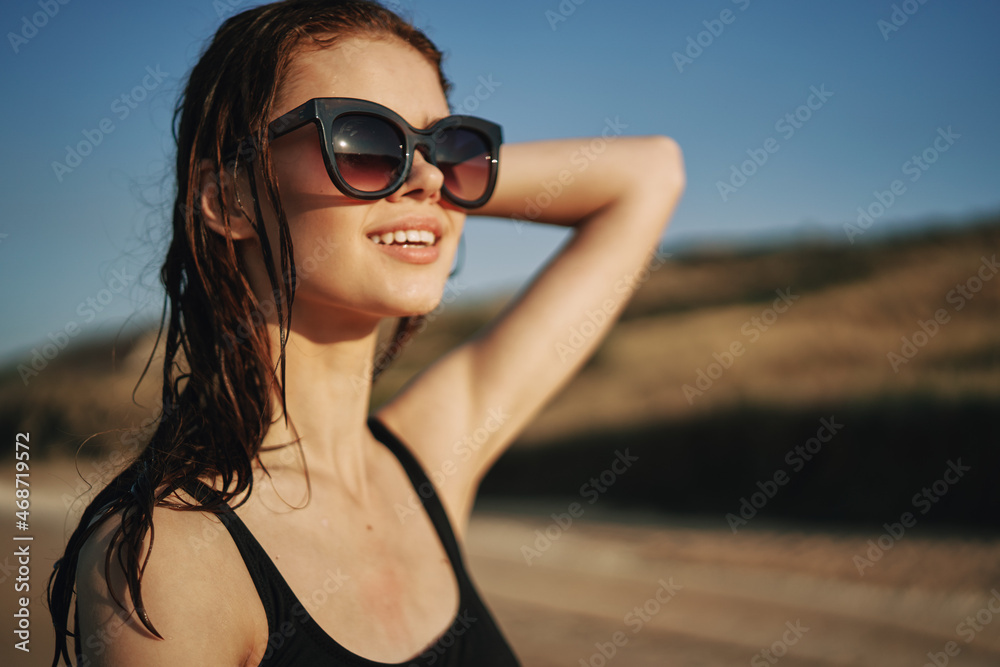 pretty woman in black swimsuit posing sun walking on the beach pretty woman in black swimsuit posing sun walking on the beach