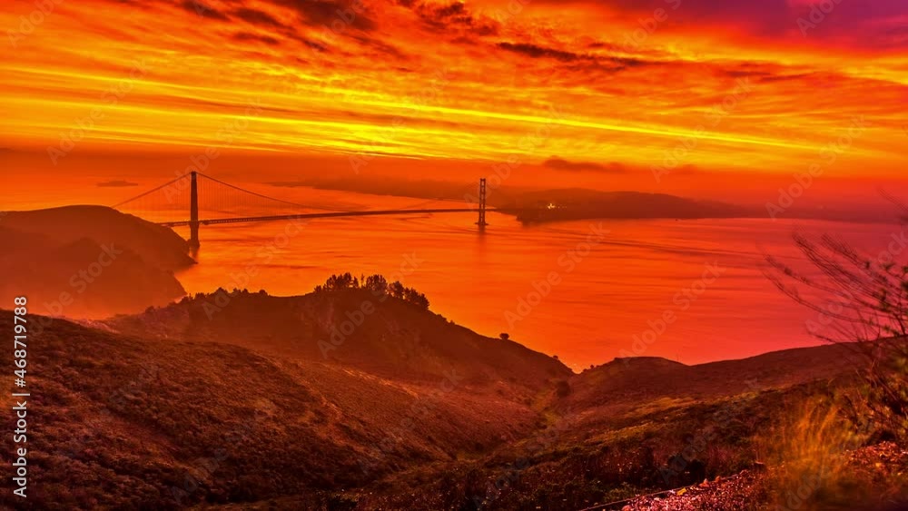 dramatic burning colored sky over Golden Gate Bridge in San Francisco bay, California. timelapse dramatic burning colored sky over Golden Gate Bridge in San Francisco bay, California. timelapse