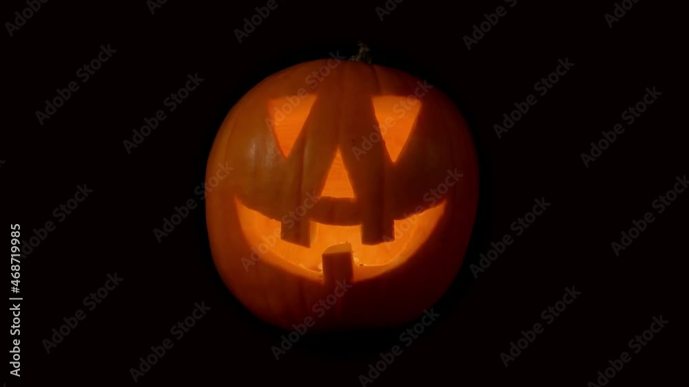 Single traditional spooky jack-o-lantern with flickering and glowing lantern fade. Traditional orange carving of face. Single traditional spooky jack-o-lantern with flickering and glowing lantern fade. Traditional orange carving of face.