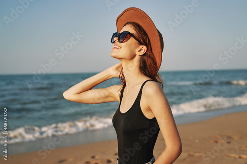 woman in a hat sunglasses by the ocean travel sun