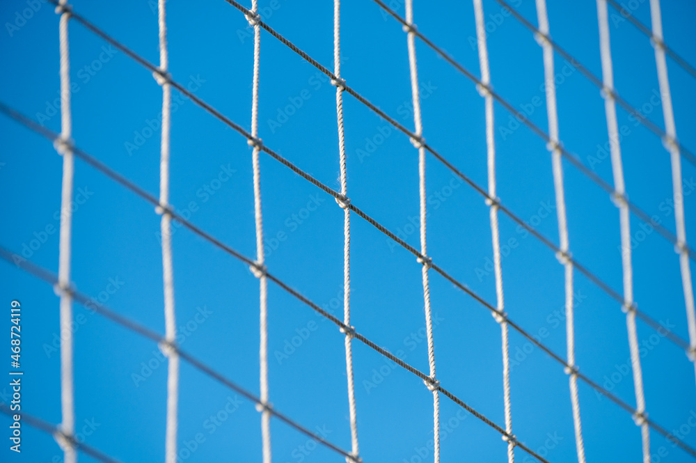 Football or soccer net background, back view of goal net with blurred stadium and field field field. Football or soccer net background, back view of goal net with blurred stadium and field field field.