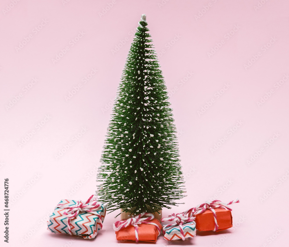 Christmas tree bauble with gift boxes on a pink background Christmas tree bauble with gift boxes on a pink background