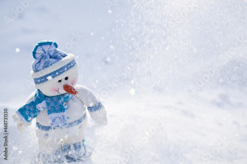 Little snowman with carrot nose in the snow. © volff