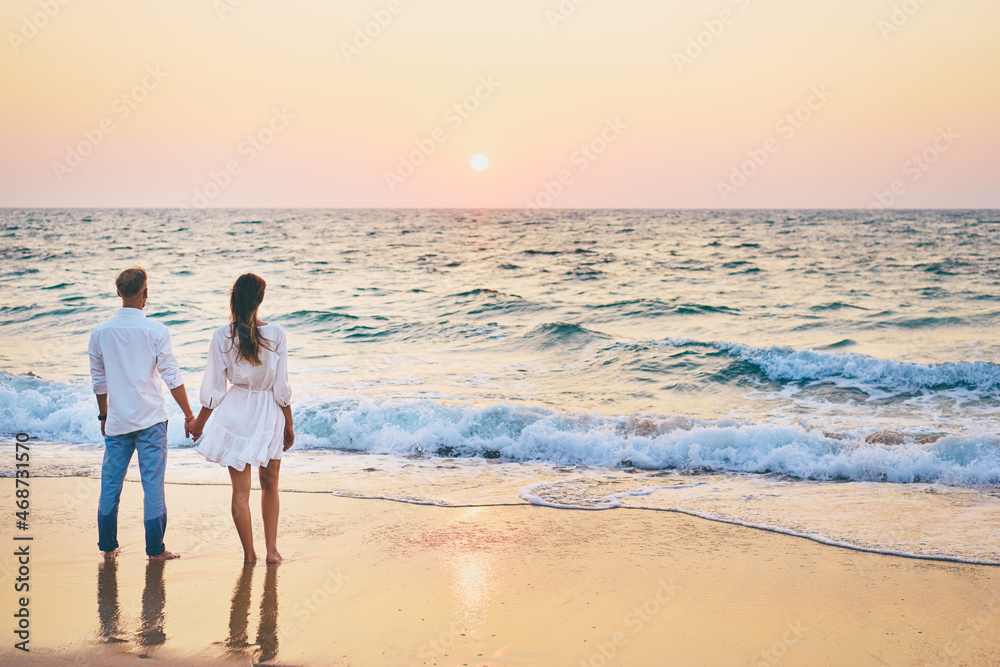 Young loving couple on the sea beach.