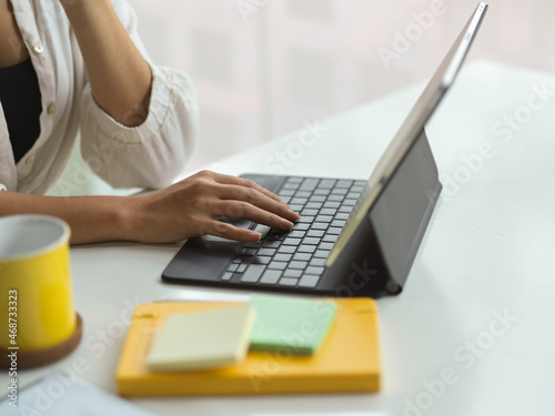 Female manager works on her modern portable tablet computer.