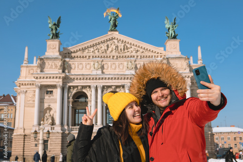 couple tourists taking selfie in front of opera building