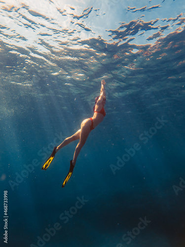 sexy woman swimming underwater in diving mask with flippers