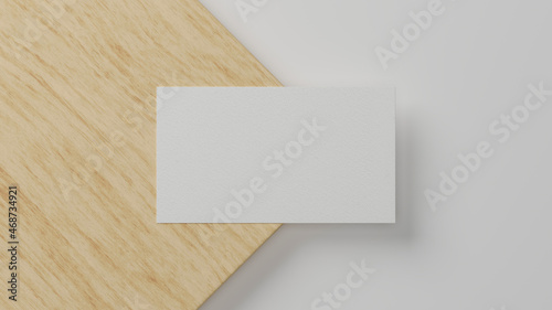 Blank business card over minimal wood and white material background. © bongkarn