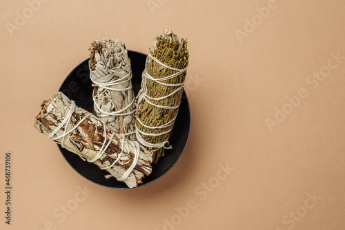 Set of incense for fumigation. Branches of white sage with cedar tied in bunch. Top view. Organic holy plant incense from America.
