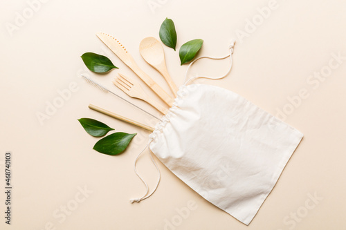 Eco friendly reusable recyclable white eco bag with kitchenware on Colored background. Concept zero waste