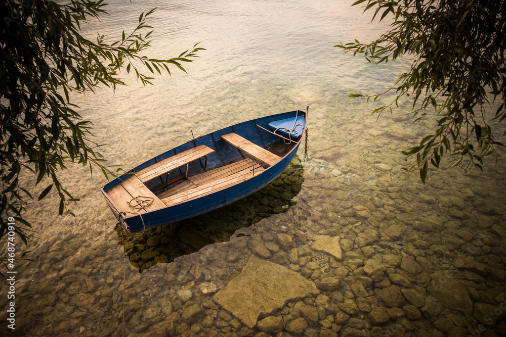 Empty wooden boat floating on water