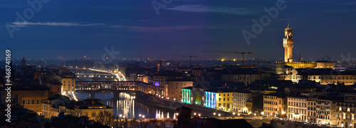 Cityscape of Florence at evening with Old Bridge and Palace of Townhall illuminated during Christmas period. Italy.