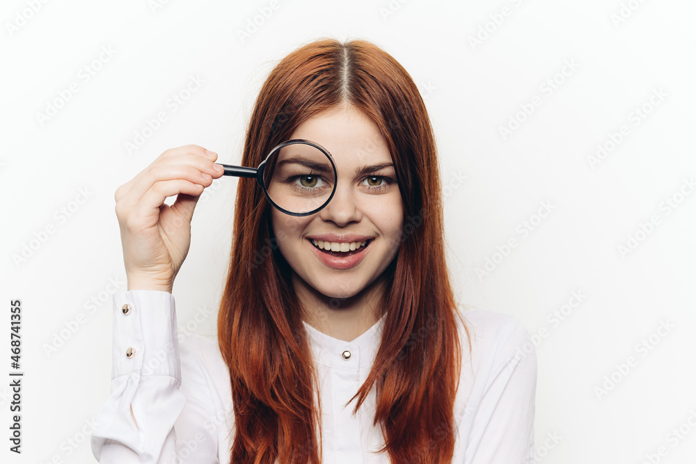 pretty woman grimacing with magnifying glass near face pretty woman grimacing with magnifying glass near face