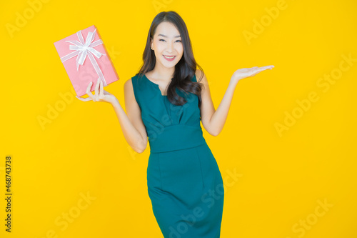 Portrait beautiful young asian woman smile with red gift box