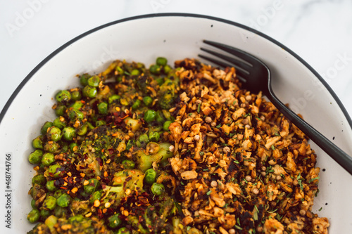 vegan broccoli and peas stiry fry with teriyaki sauce shredded tofu, healthy plant-based food photo