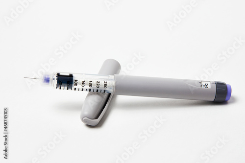 Insulin pen with insulin medicine on white background
