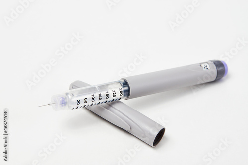 Insulin pen with insulin medicine on white background