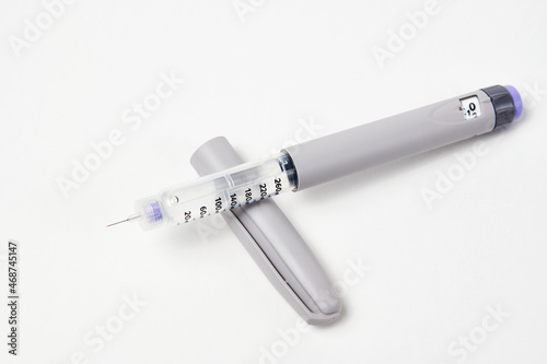 Insulin pen with insulin medicine on white background