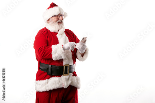 Santa Claus using a mobile phone on white background