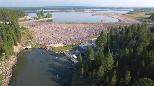 Beautiful aerial view of a dam and lake in Island park Idaho.  Also seeing a wide of a small hydroelectric plant at the bottom and start of the river photo