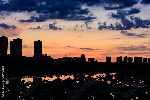 The river in the city Park reflects the city skyline against a beautiful and spectacular sunset backdrop.