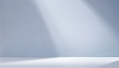 Minimal abstract light blue background for product presentation. Shadow and light from windows on plaster wall.