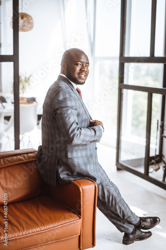 Happy Smiling Rich African American Businessman. Successful Media Tycoon In Stylish Expensive Suit in luxury apartment. Concept Of Rich Life, Successful, Luxury Lifestyle People