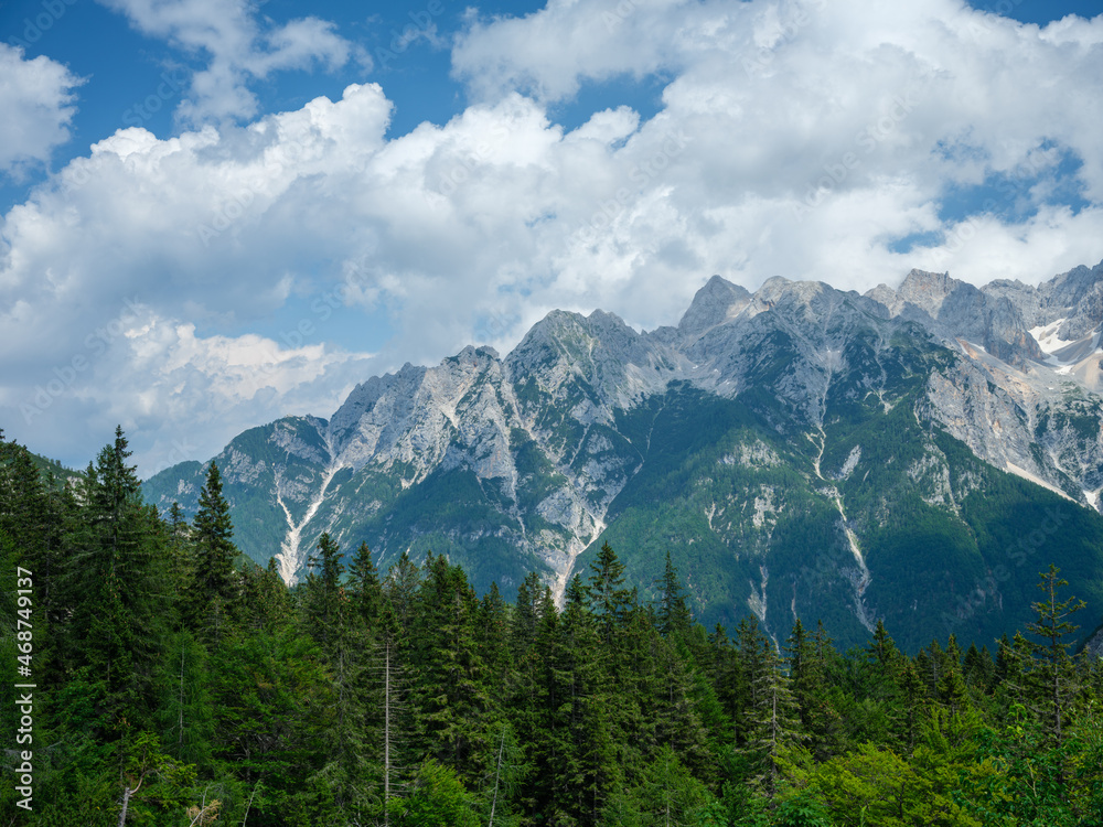 summer mountain tops and peaks under blue cloudy sky in Slovenia national Triglav park