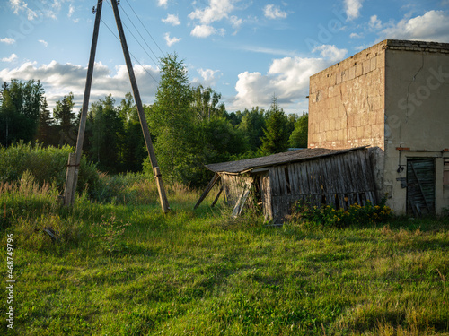 old countryside barn from wooden planks and concrete in rural area